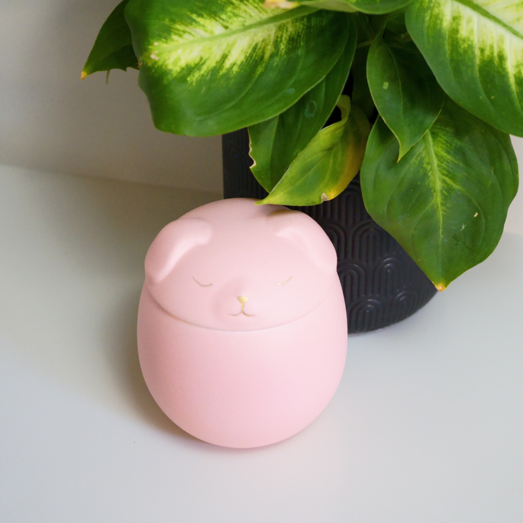 Pink canine companion ceramic urn in natural setting